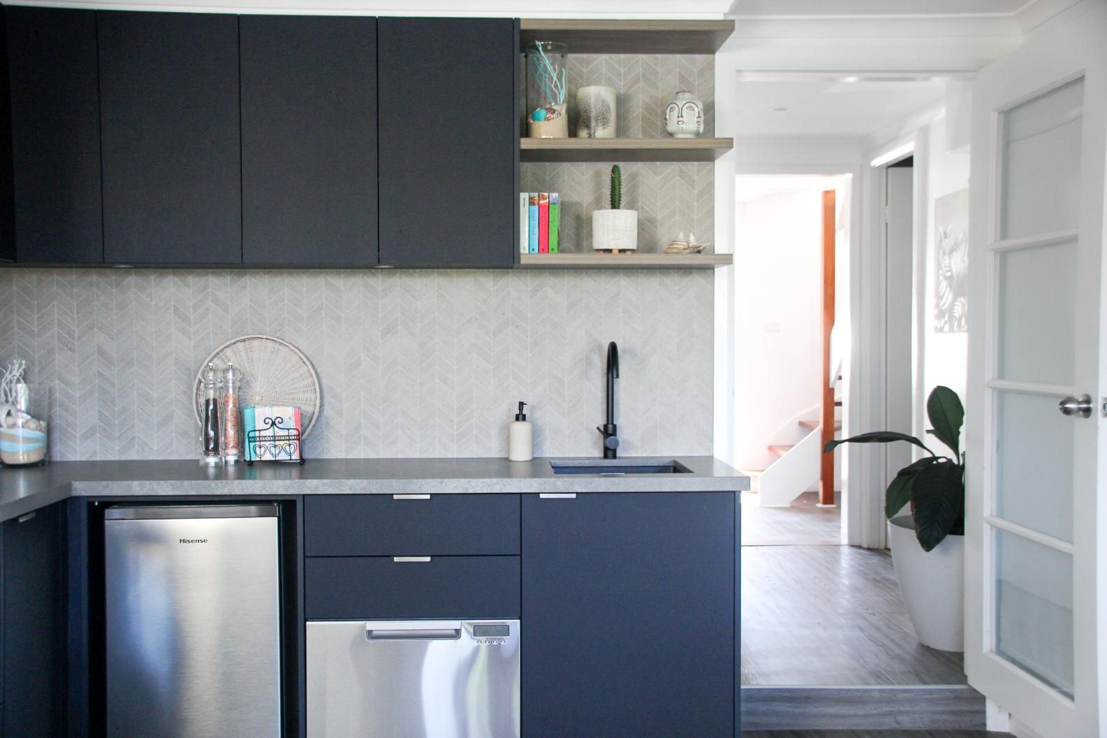 A Kitchen With Black Cabinets , Stainless Steel Appliances — Viison Kitchens & Joinery Forster In Gloucester, NSW
