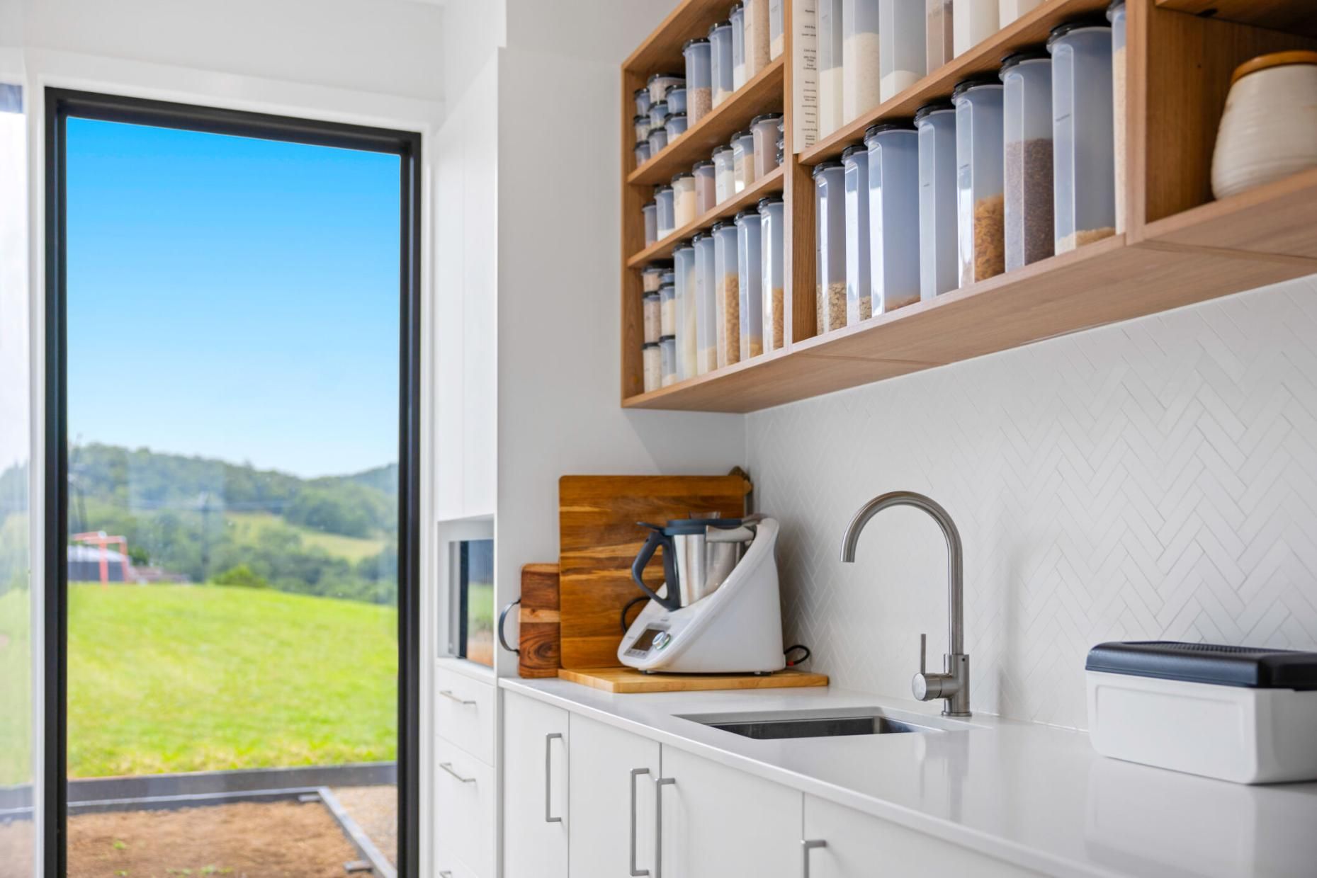 A Kitchen With A Sink , Shelves , And A Sliding Glass Door — Viison Kitchens & Joinery Forster In Forster, NSW