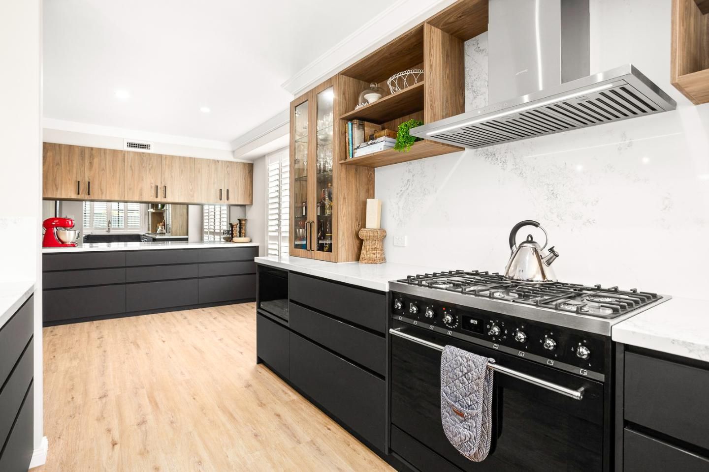 A Kitchen With Black Cabinets And A Stove Top Oven — Viison Kitchens & Joinery Forster In Bulahdelah, NSW