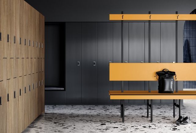 A locker room with a bench and a row of lockers. — Viison Kitchens & Joinery Forster In Forster, NSW