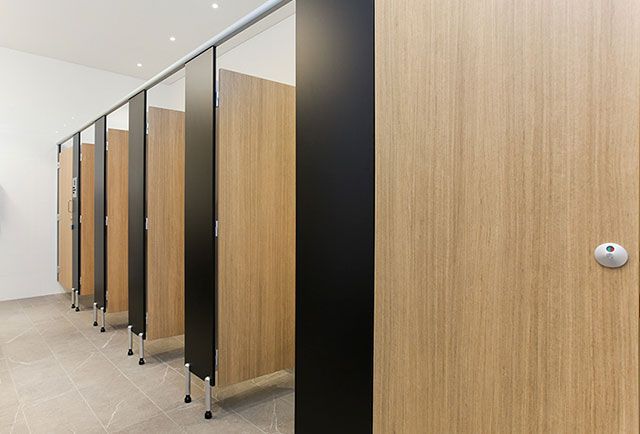 A row of wooden toilet cubicles in a public restroom. — Viison Kitchens & Joinery Forster In Forster, NSW