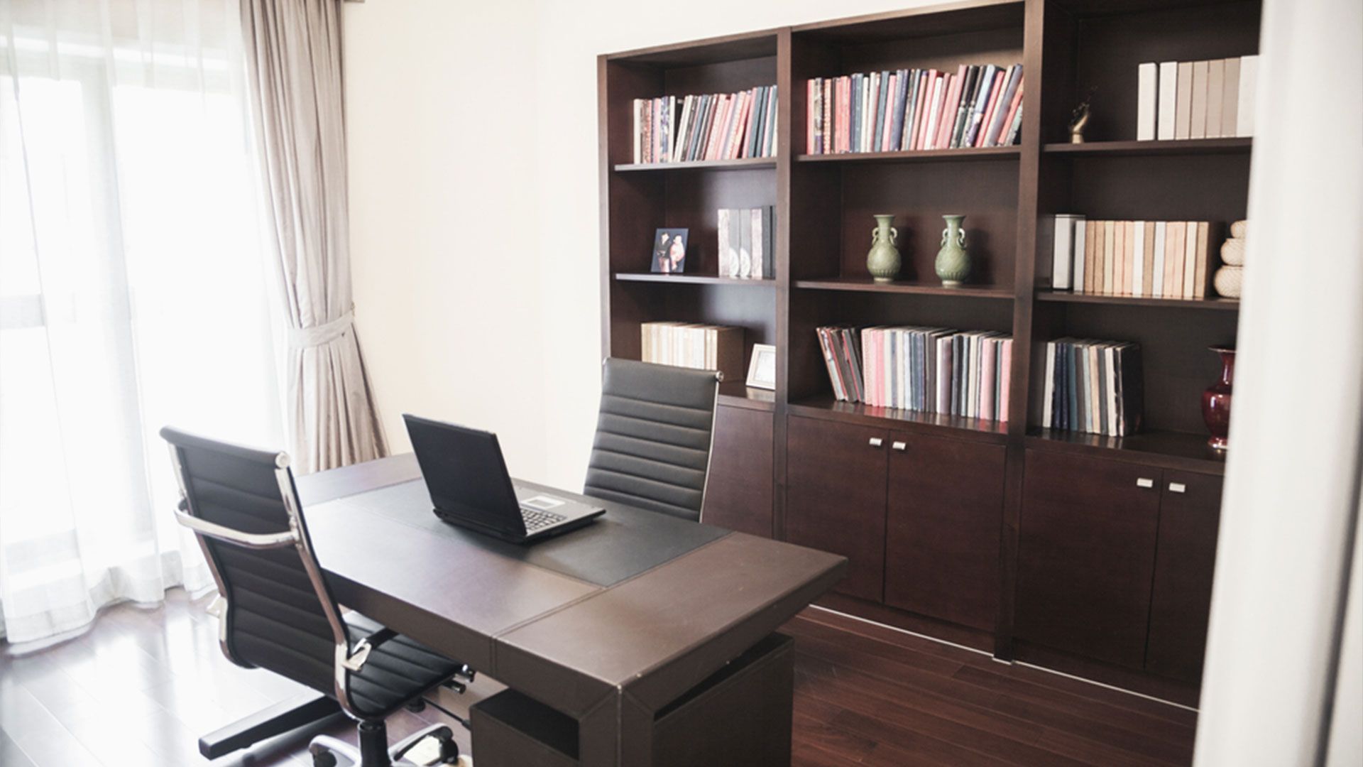 A Desk With Two Chairs And A Laptop On It — Viison Kitchens & Joinery Forster In Forster, NSW