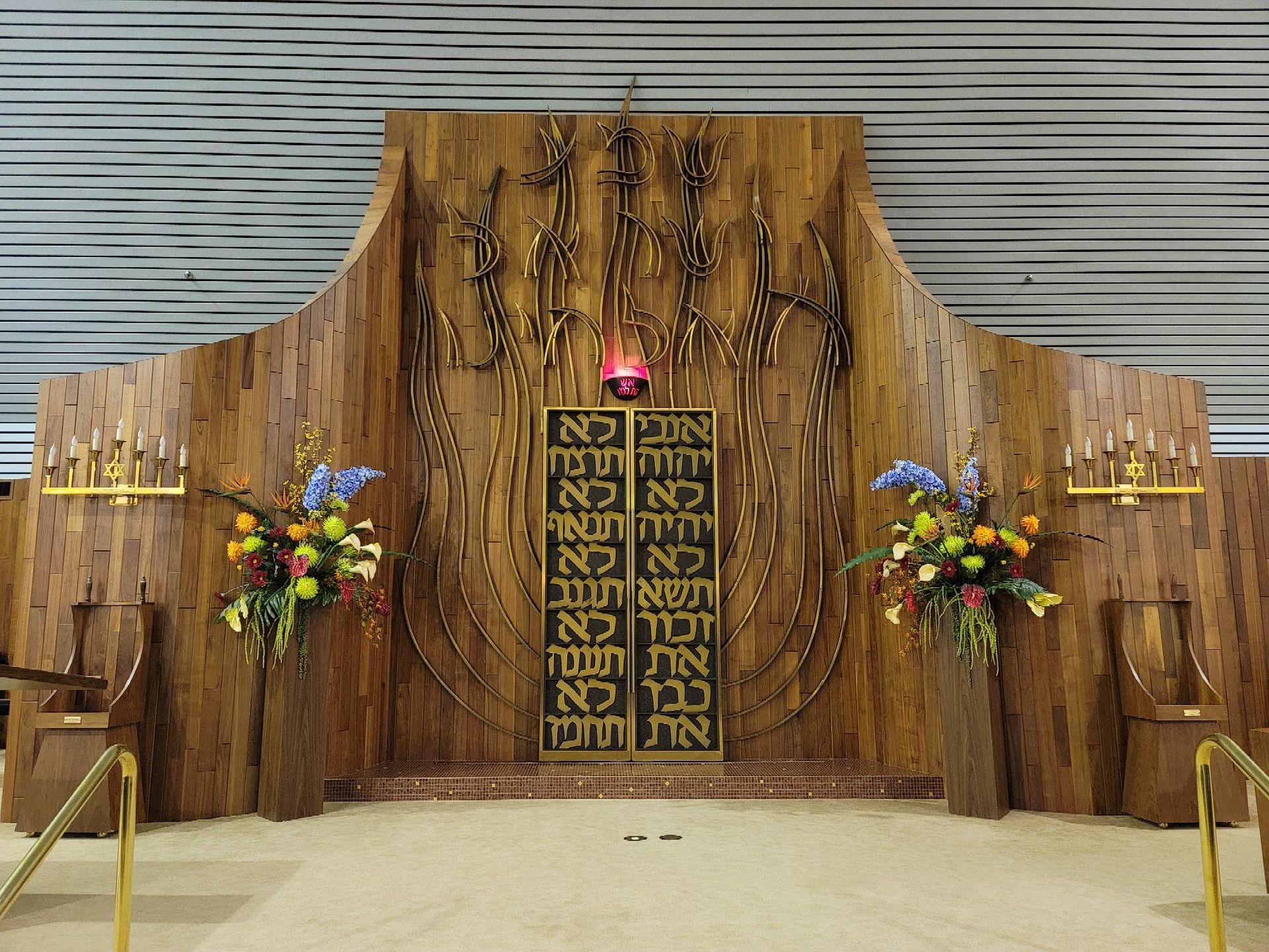 A wooden wall with hebrew writing on it