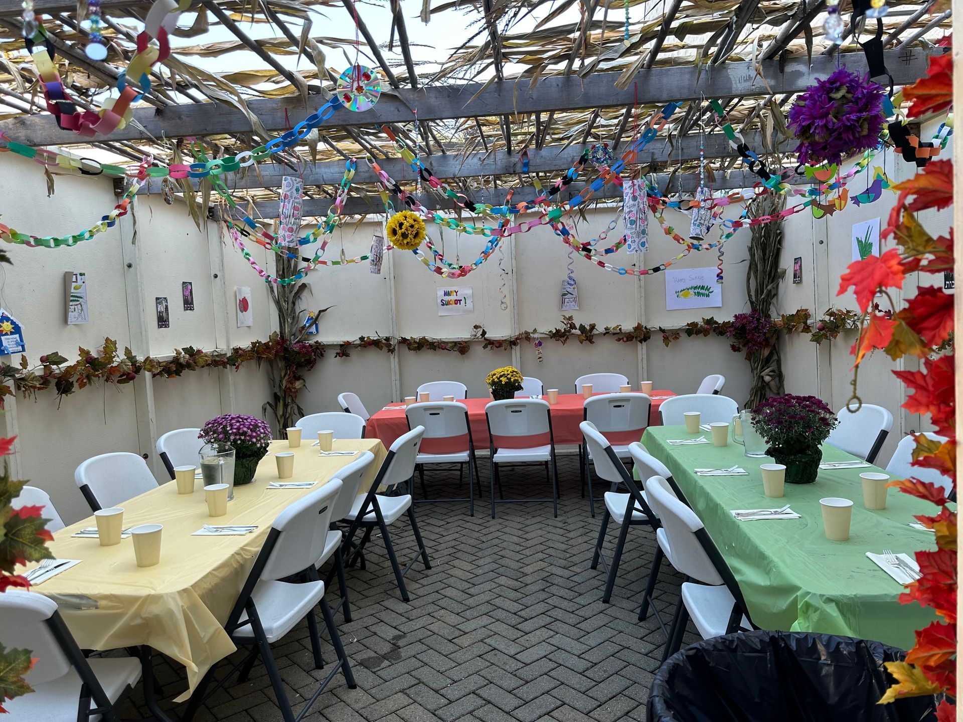A room with tables and chairs set up for a party.