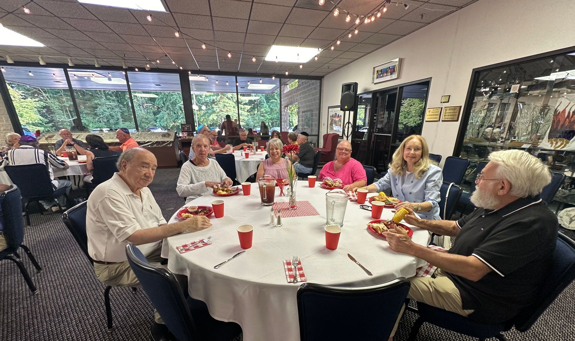 Three women are posing for a picture together in a room.