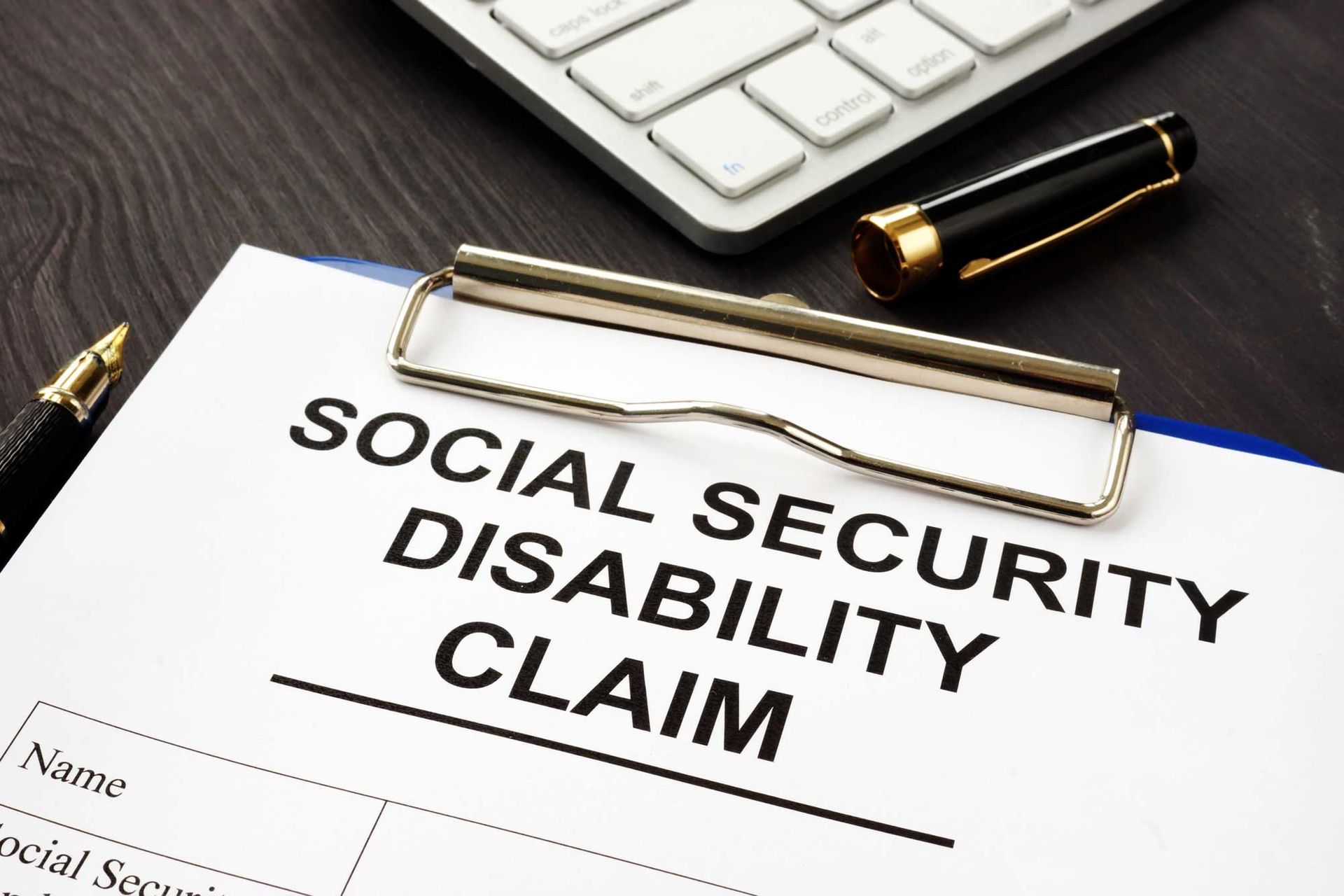 Closeup of a clipboard with a form that reads: ”Social Security Disability Claim
