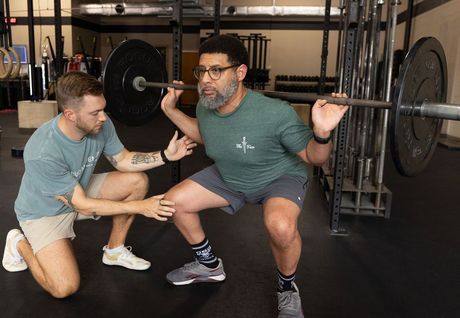 A man is getting a knee massage from a doctor.