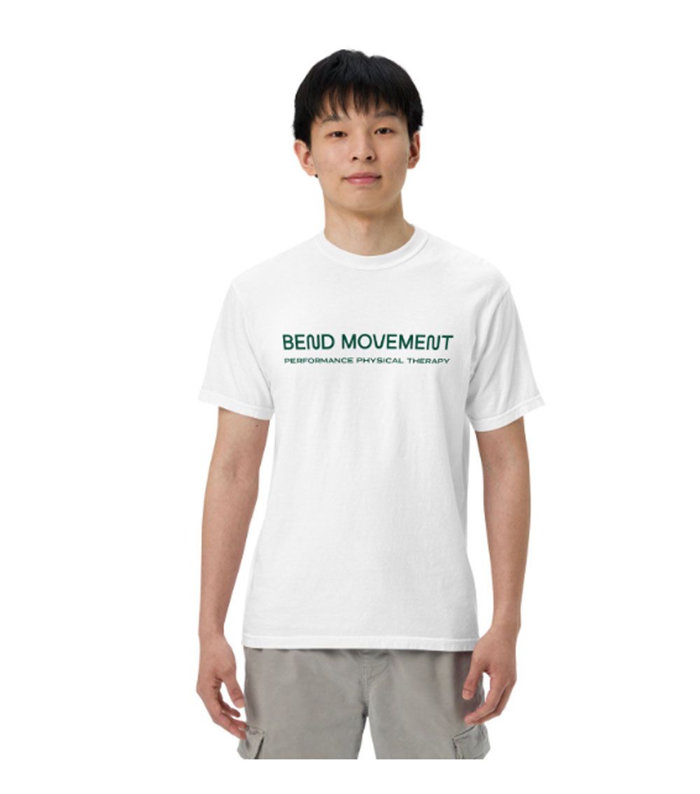 A man wearing a white t-shirt that says bend movement