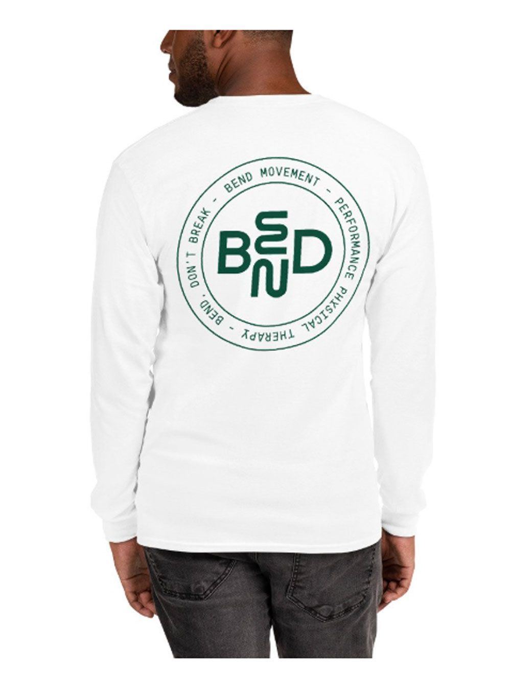 A man is wearing a white long sleeve t-shirt with a green logo on the back.