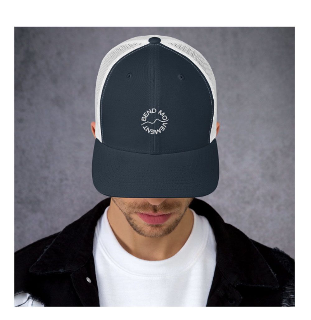 A man wearing a hat with a clock on it