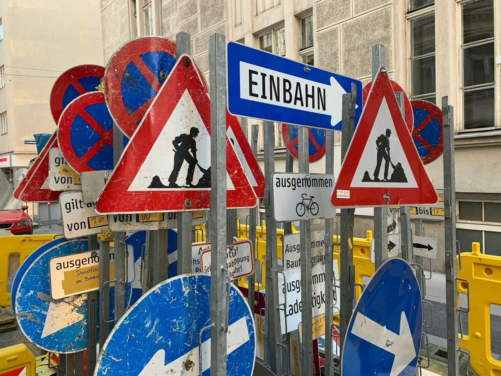 A bunch of street signs including one that says einbahn