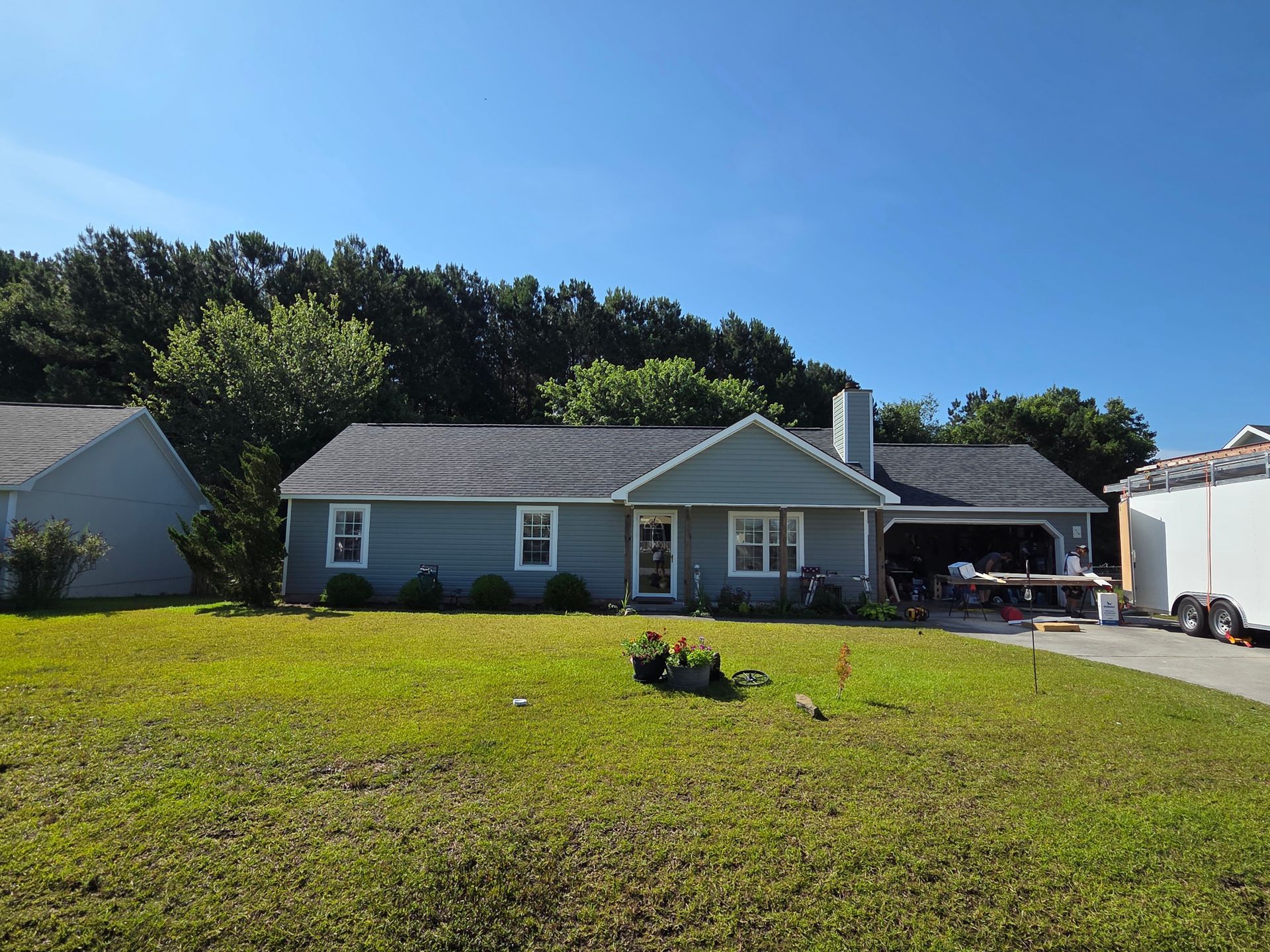 A house with a large grassy yard in front.