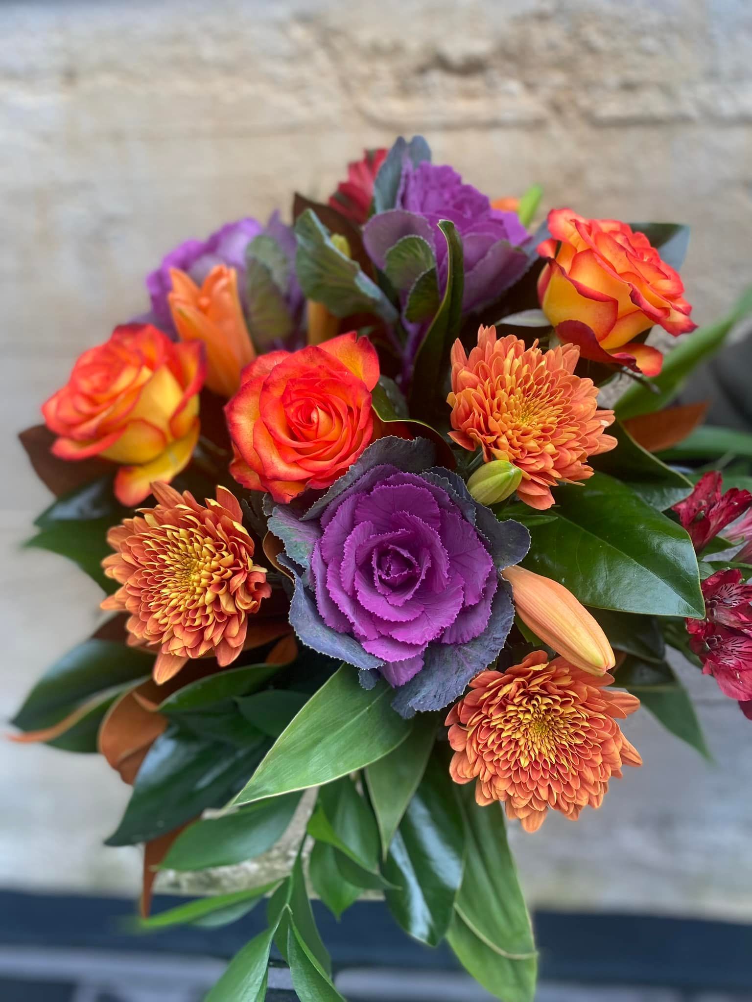 a bouquet of flowers with purple and orange flowers