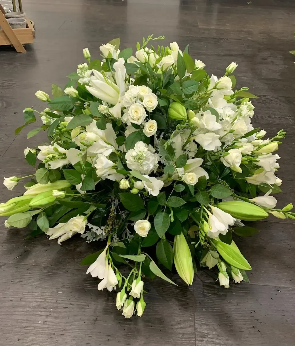 two wreaths of flowers are sitting next to each other