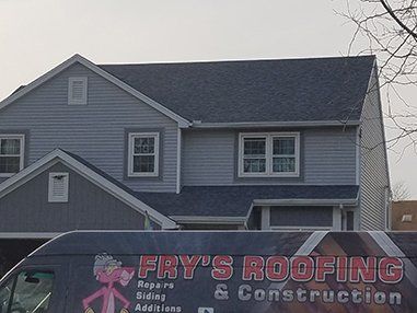 Residential Roof with Fry's Roofing Vehicle in Front — Toledo, OH — Frys Roofing and Construction