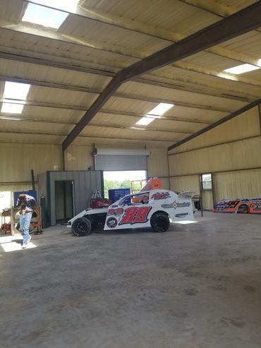 Race car inside a large metal building