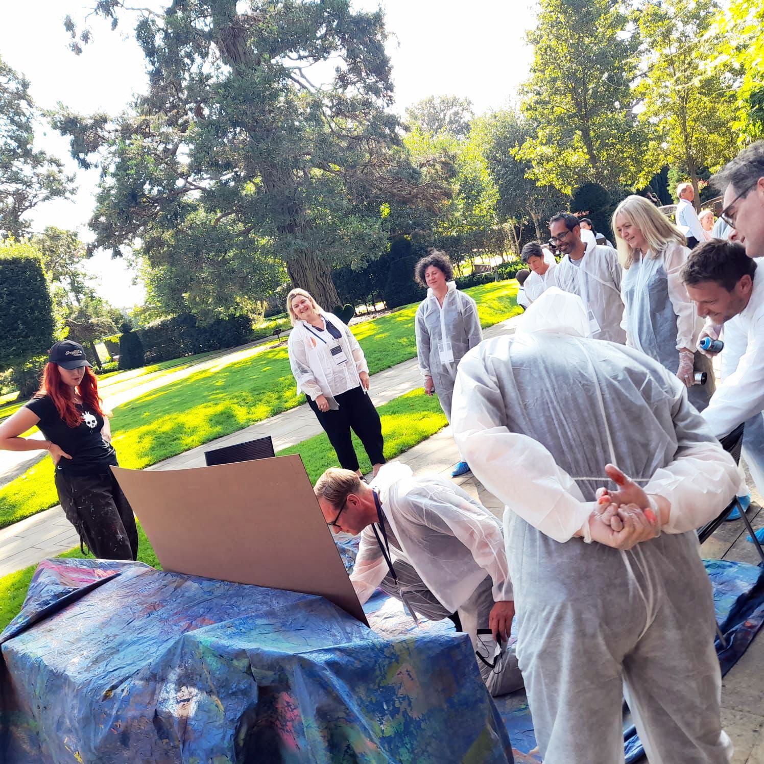Man spray painting a graffiti board