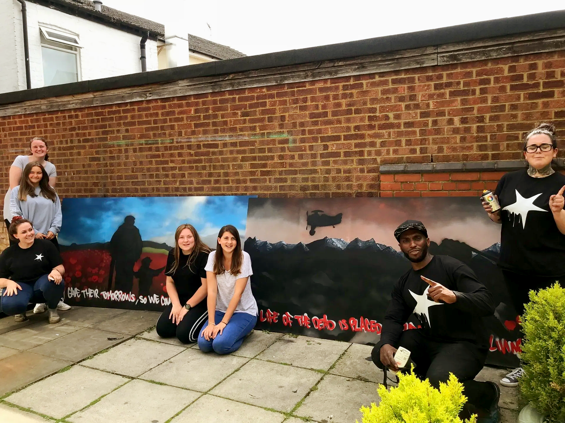 Collaborative graffiti mural board painted by year 6 pupils during a structured street art workshop led by professional graffiti artists