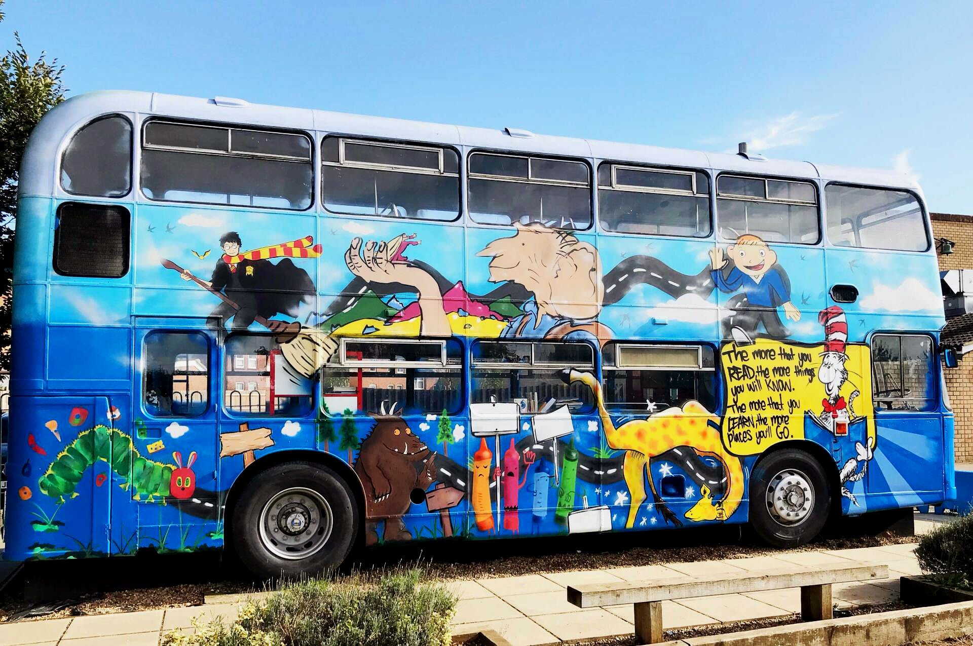 Graffiti-covered double-decker bus transformed into a colourful street art installation during a Graffiti Stars school workshop.