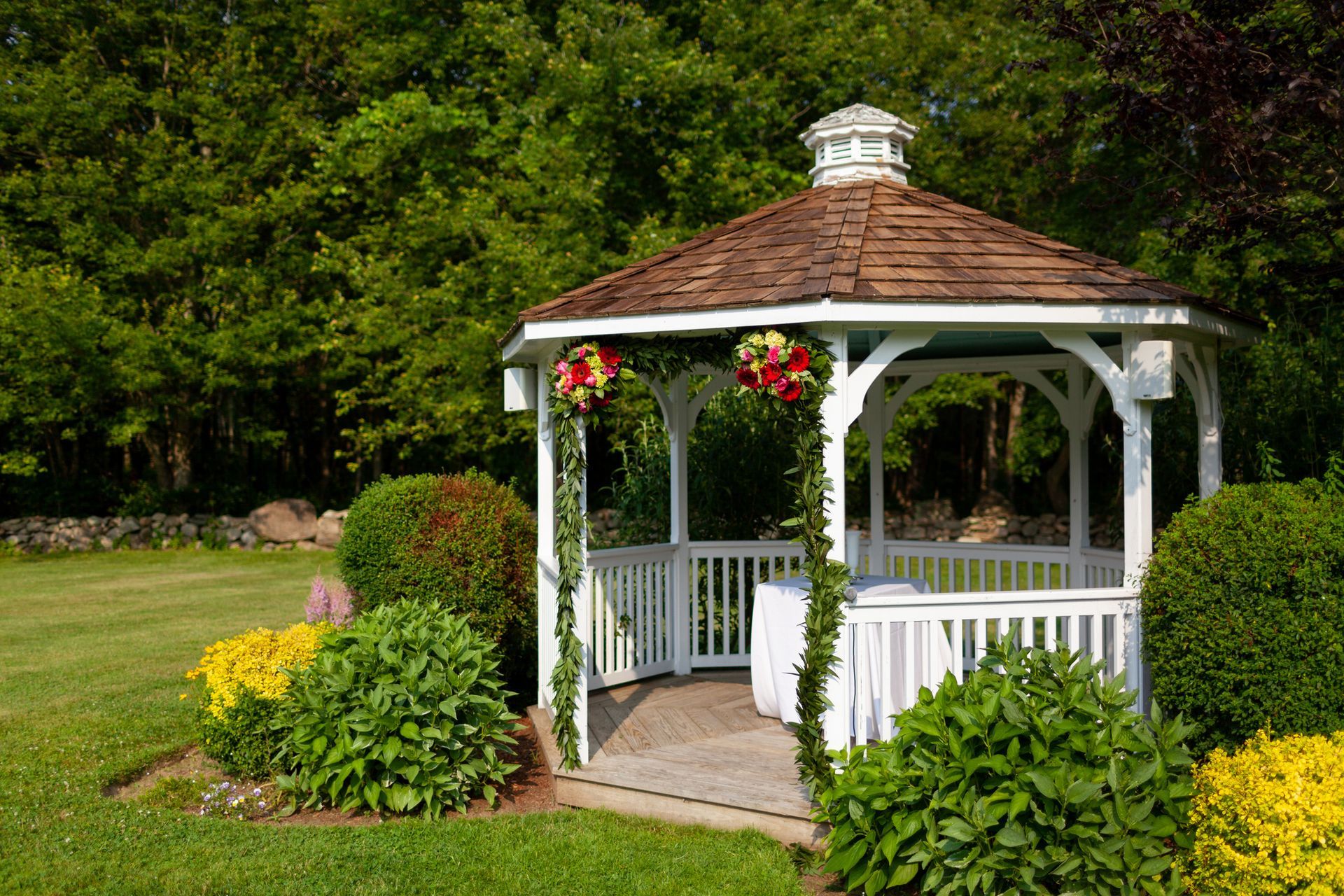 A concrete walkway leading to a shed next to a house.