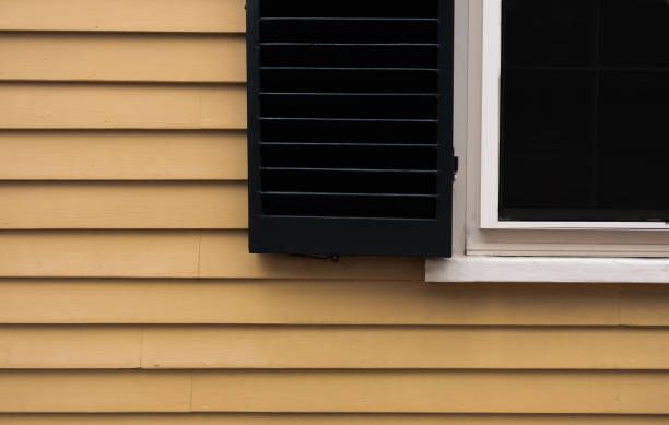 A small house with a porch and a satellite dish on the roof