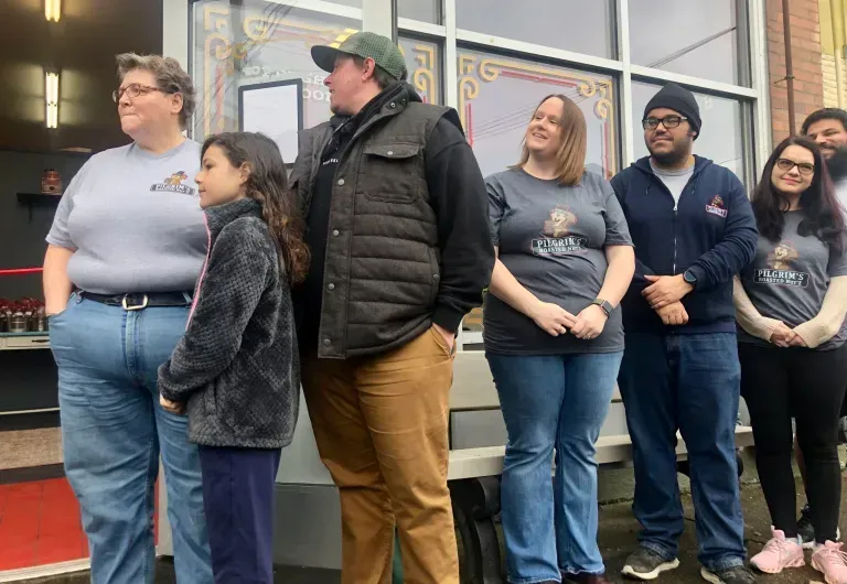 A group of people are standing in front of a building.