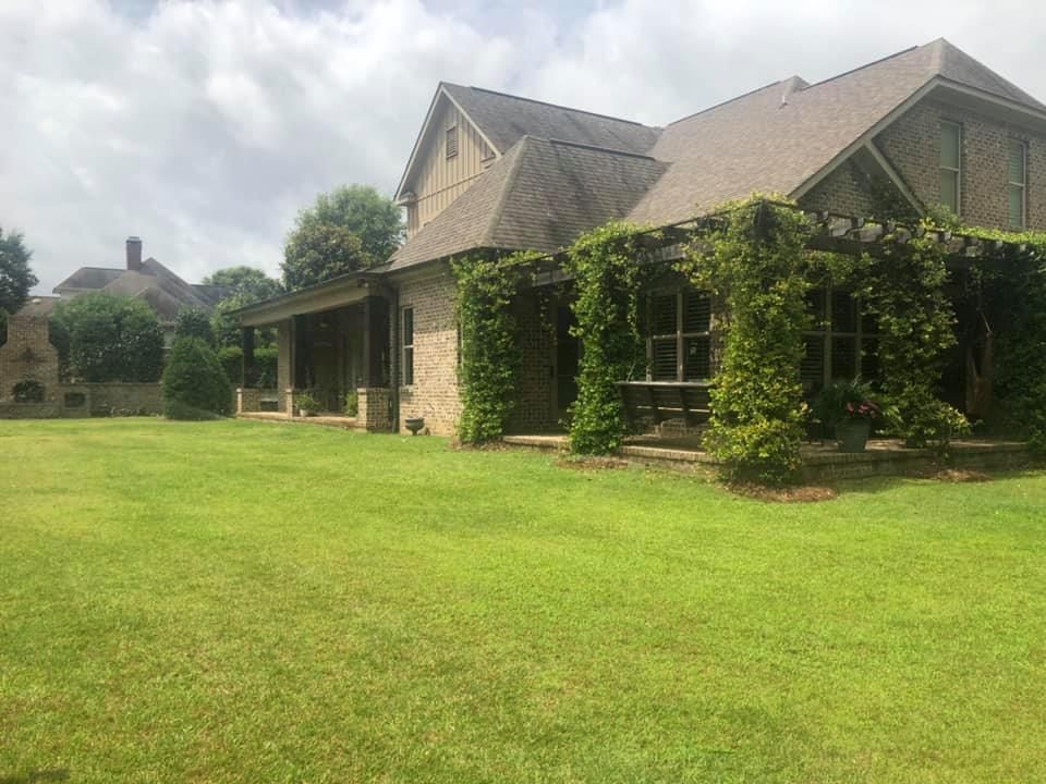A large house with a large lawn in front of it.