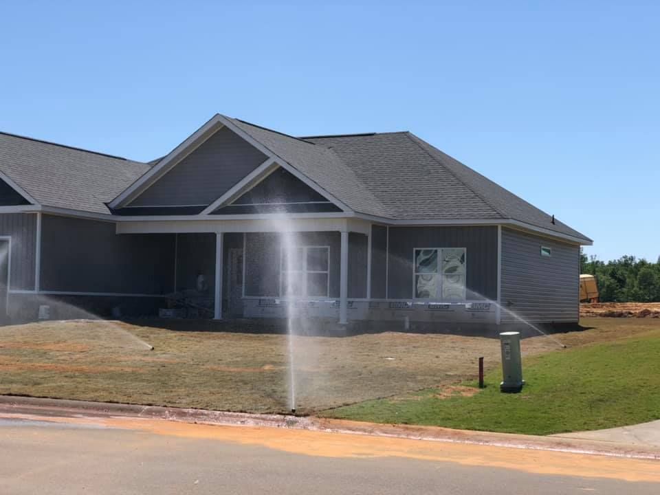 A house with a large lawn in front of it.