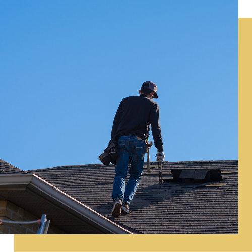 A man is standing on top of a roof.