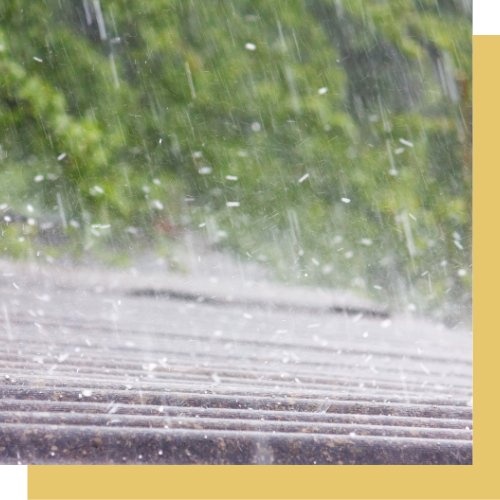 A close up of rain falling on a roof.