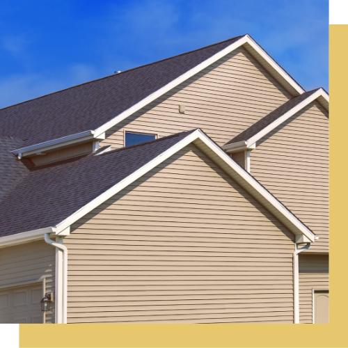 The roof of a house with a blue sky in the background.