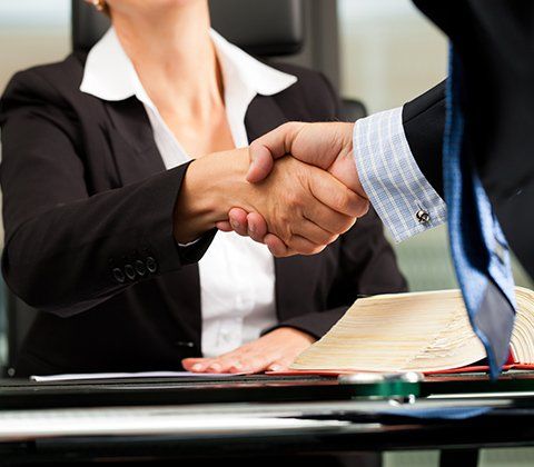Female Attorney Shaking Hands with Her Client — New London, CT — Santa Mendoza