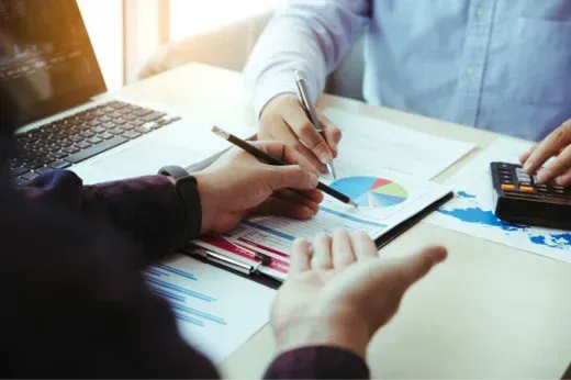 A man in a hard hat is holding a large piece of wood ..