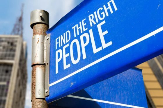 Large blue street sign reading Find the Right People