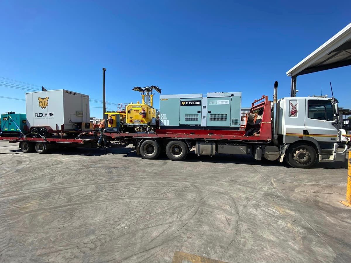 A Tow Truck Is Carrying a Trailer with A Generator on It — Offset Tilt Trays In Biloela, QLD