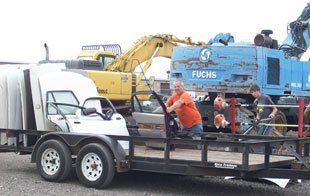 Man Carrying The Donated Car Parts — Kankakee, IL — Acme Auto Parts