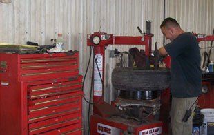 Man Repairing A Tire — Kankakee, IL — Acme Auto Parts