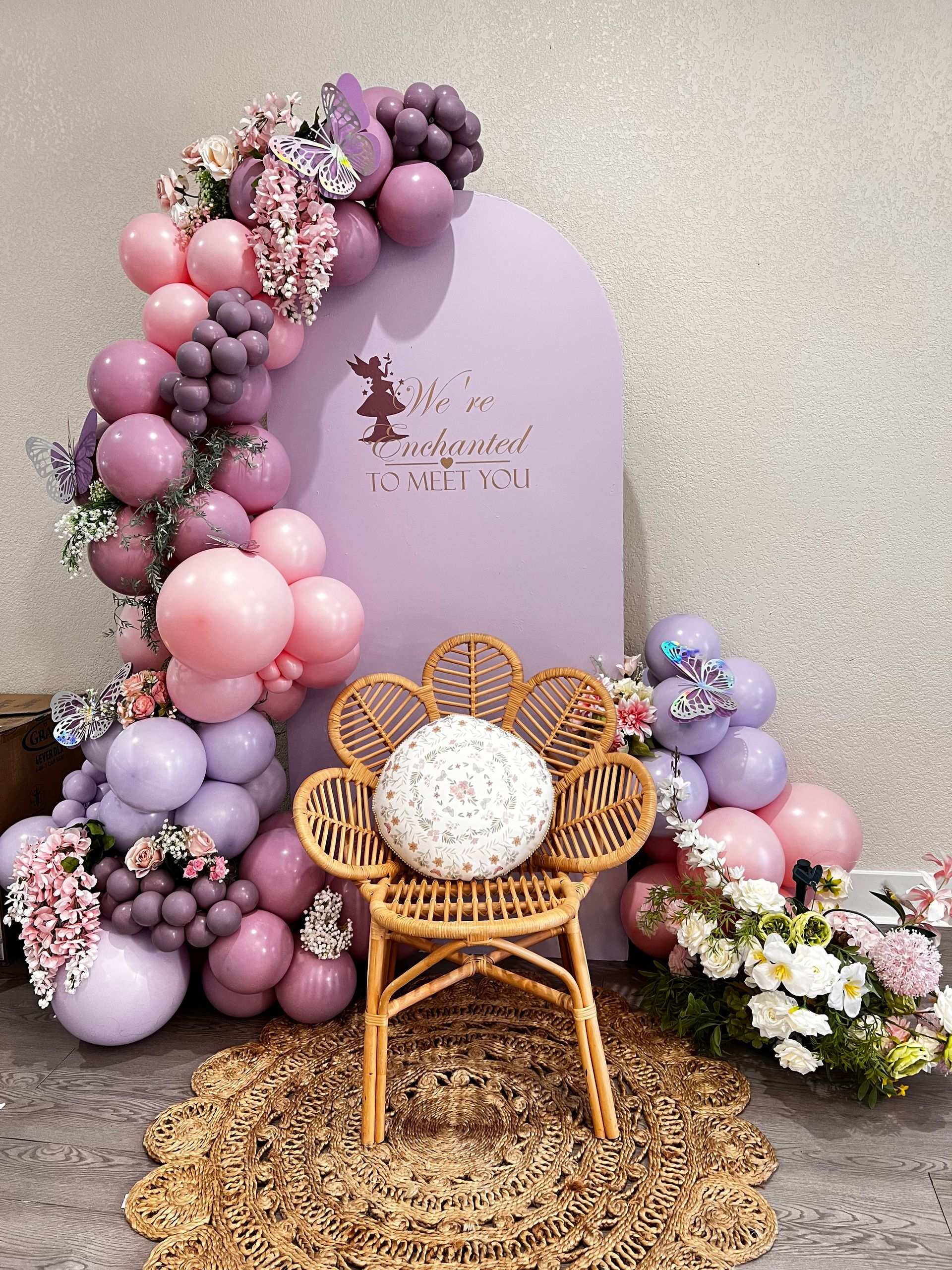 A room decorated with balloons and a winnie the pooh sign.