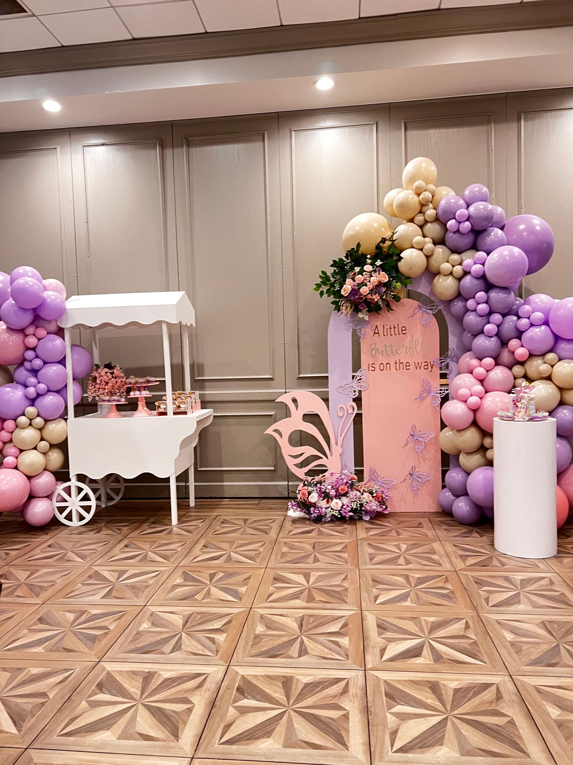 A room filled with balloons and a cart.