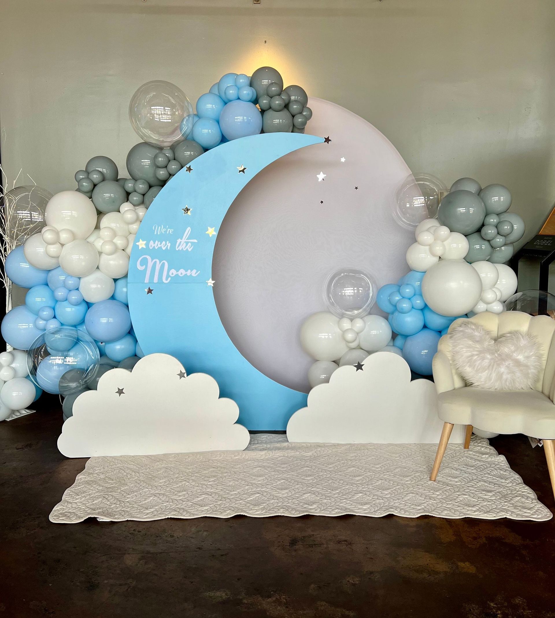 A room decorated with balloons and a crescent moon