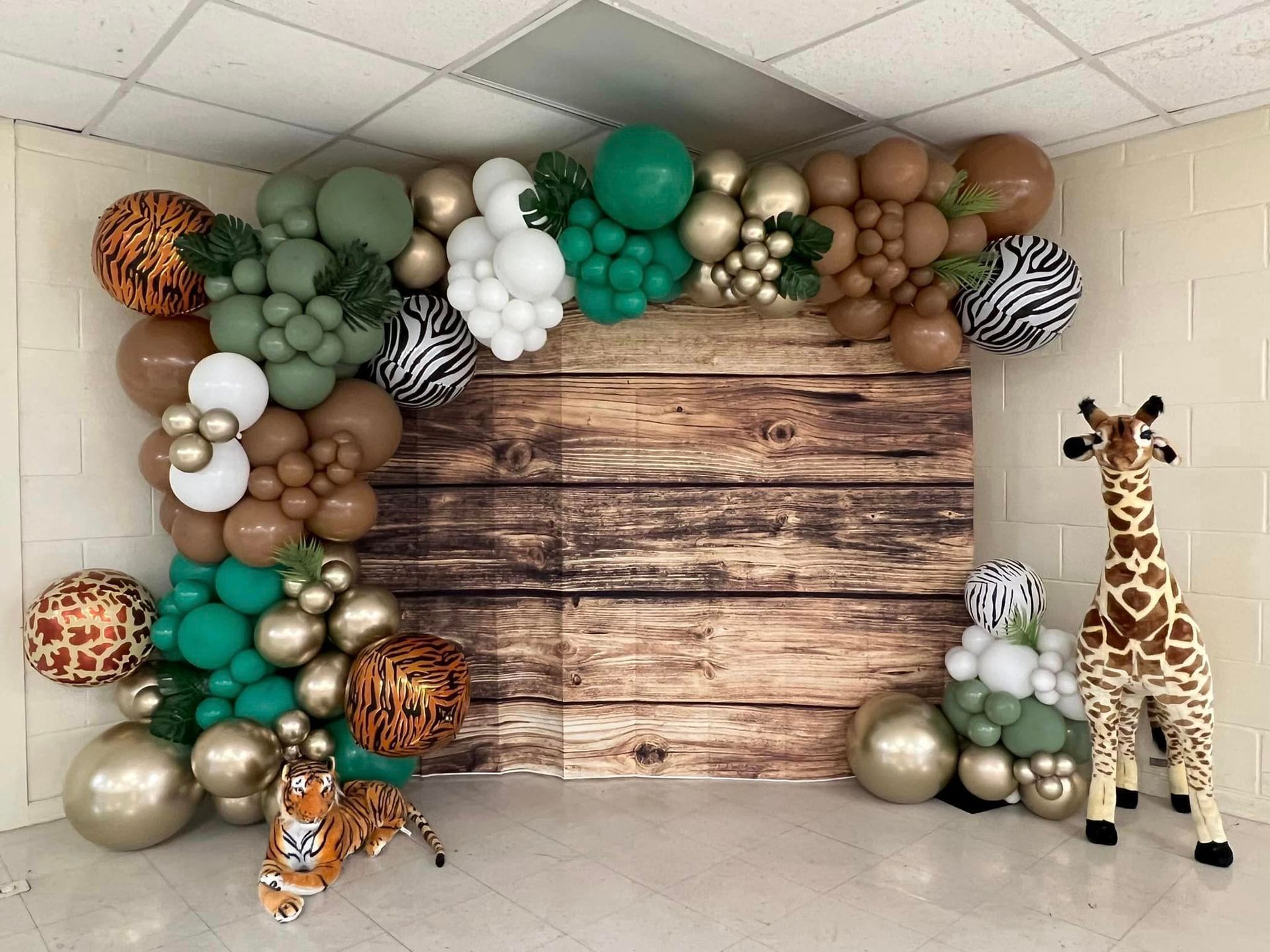 A room filled with balloons and stuffed animals.