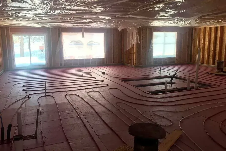 A large room with a lot of pipes on the floor.
