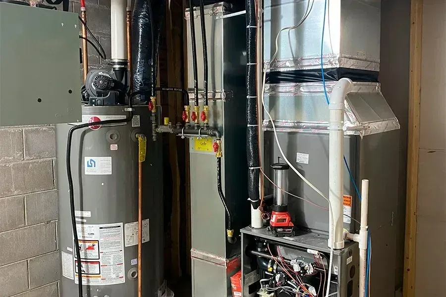 There is a water heater and a furnace in the basement.
