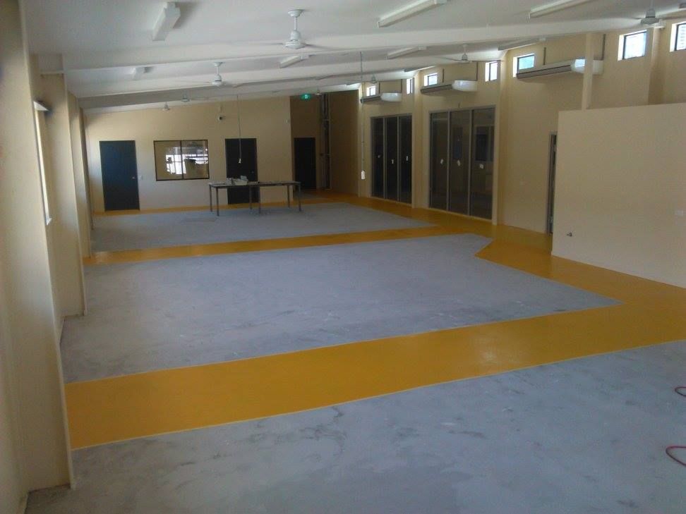 Large Empty Room With a Yellow and Blue — Australian Epoxy Floors in Rockhampton, QLD