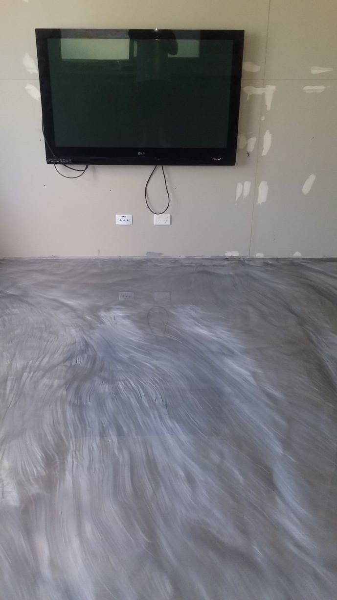 Flat Screen Tv is Mounted to the Wall in a Living Room — Australian Epoxy Floors in Rockhampton, QLD