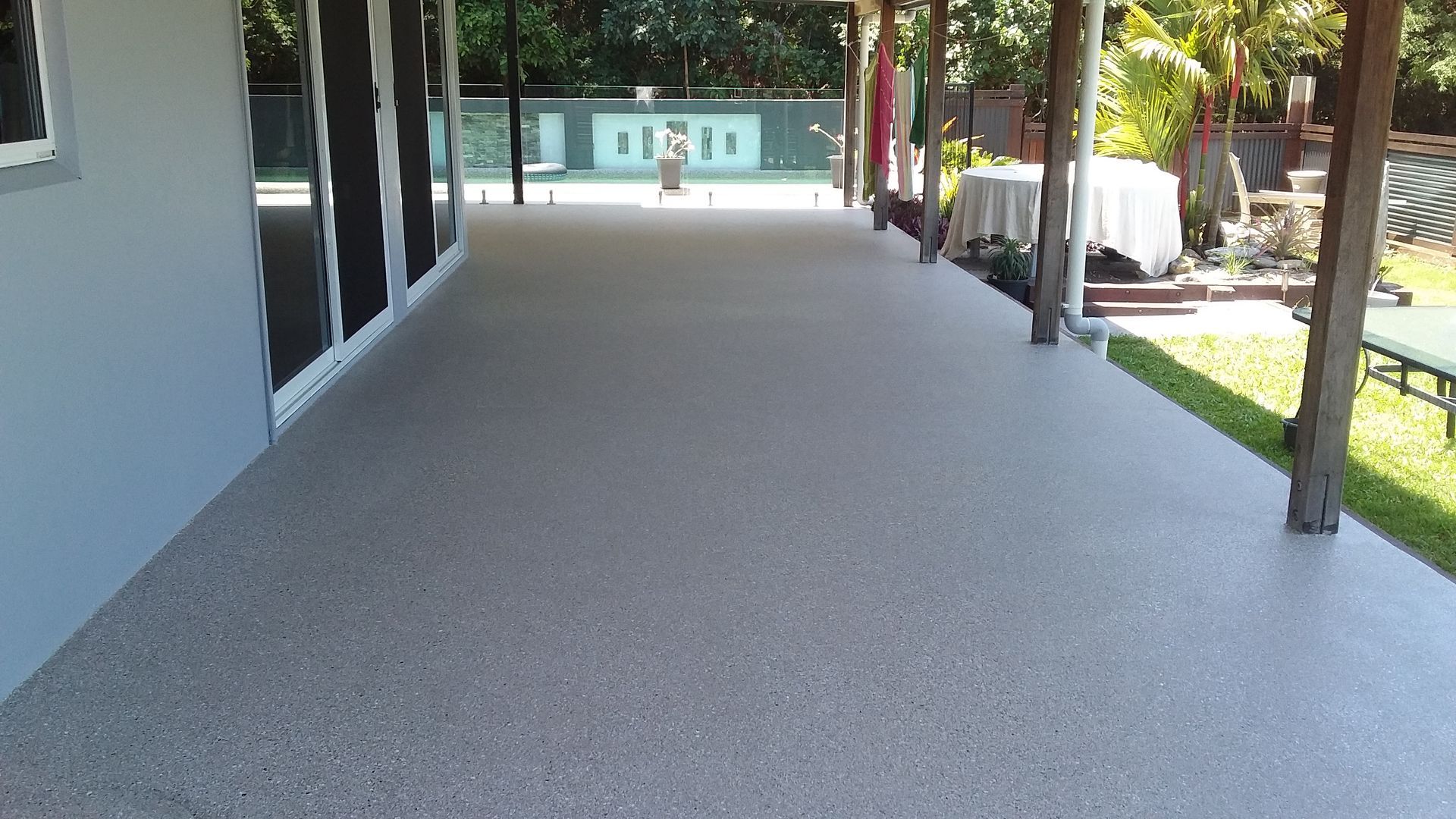 Outdoor Patio with grey speckle epoxy flooring — Australian Epoxy Floors in Rockhampton, QLD