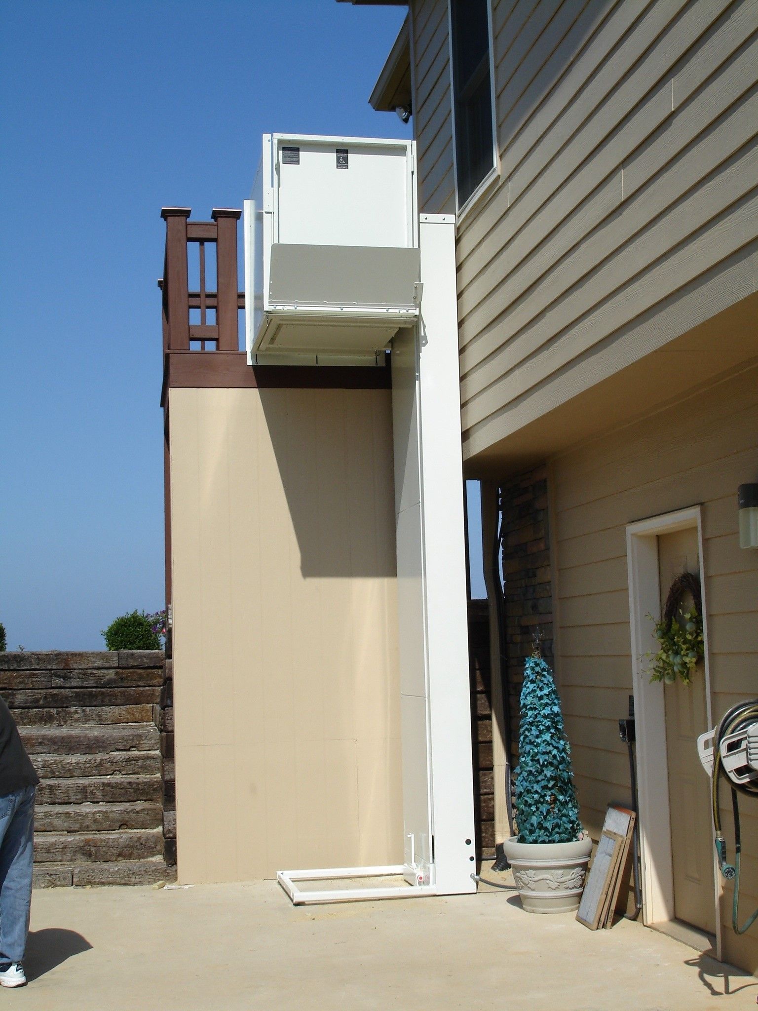 A wooden ramp leading to the front door of a house