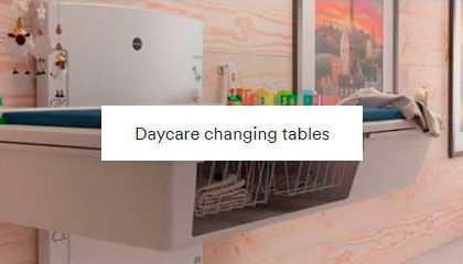 A bathroom with a sink and a daycare changing table.