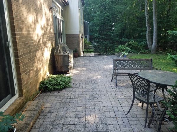 there is a table and chairs in the backyard of a house .