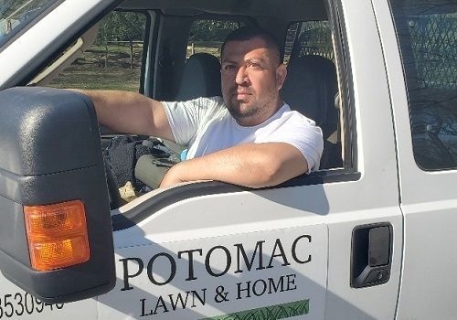 a man is sitting in the driver 's seat of a white truck .